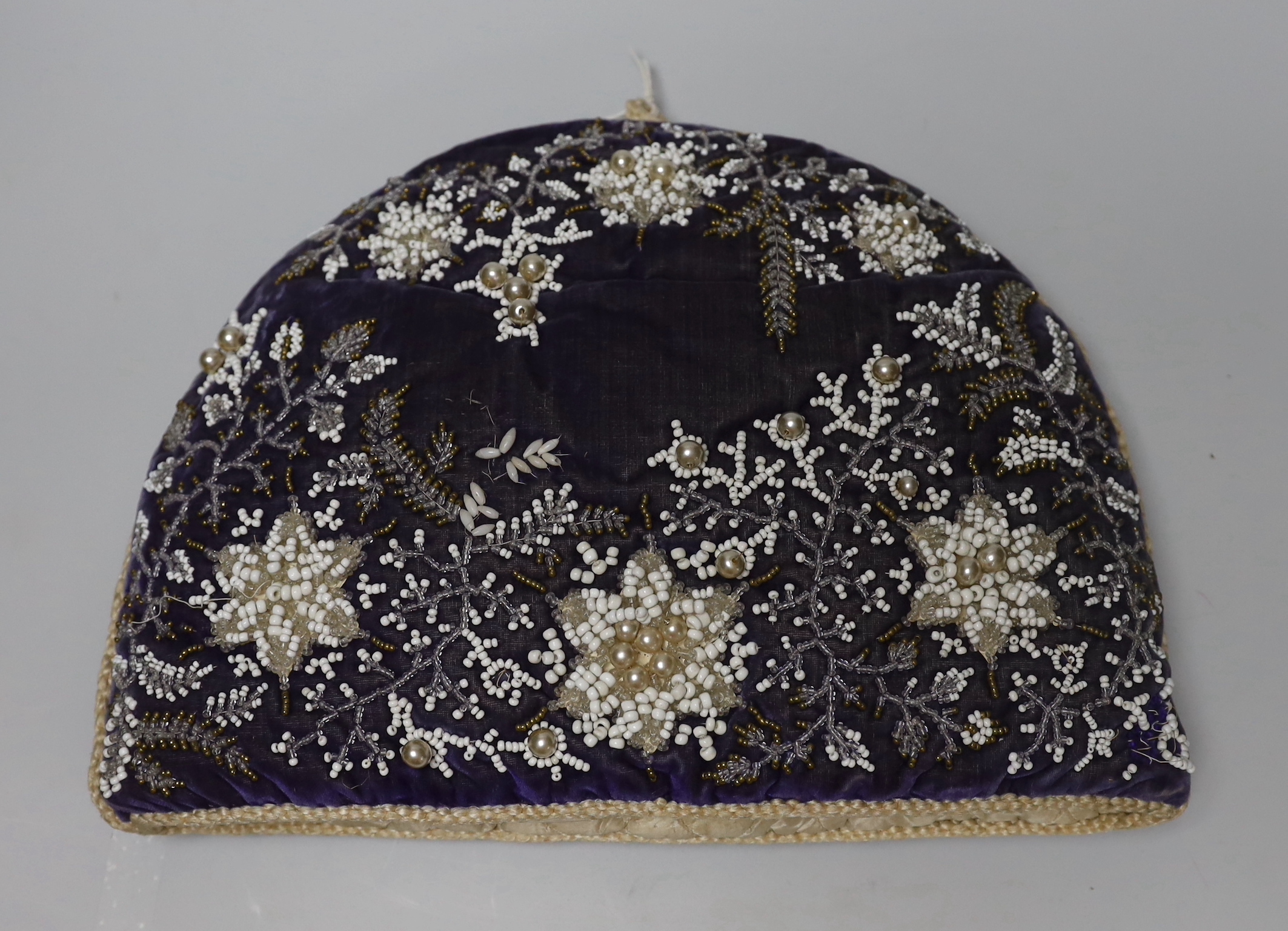 A Berlin-type late 19th century cushion and tea cosy with floral beadwork embroidery, the largest 35cm wide
